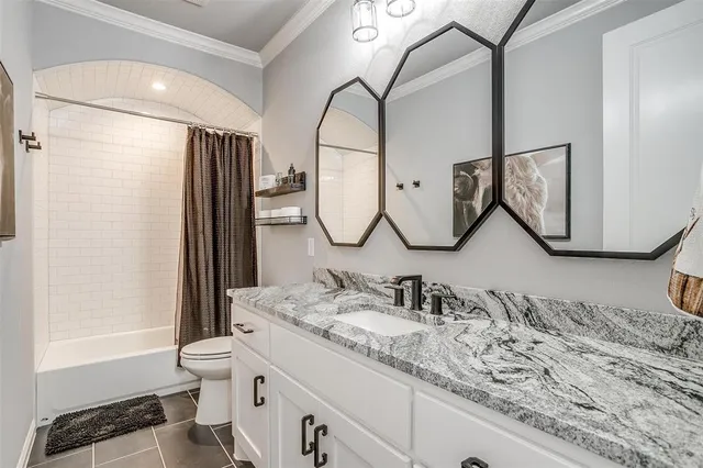 a bathroom with a double vanity sink and mirror with bathtub