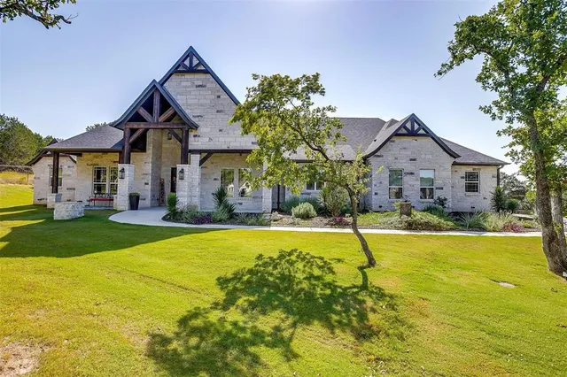 a front view of house with yard and swimming pool