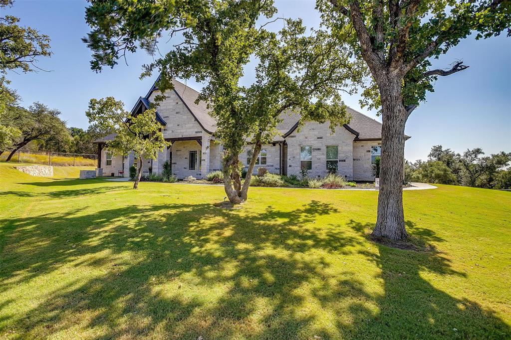 2161 Eagles Rdg Drive Weatherford, TX 76087 - Photo 5 of 40 a swimming pool with trees in front of it