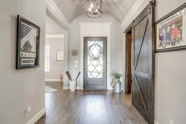a view of an entryway with wooden floor