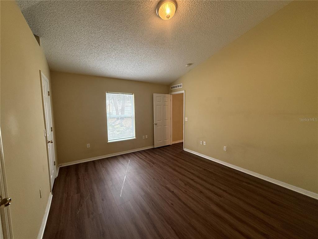 2156 Deltona Boulevard Spring Hill, FL 34606 - Photo 12 of 21 a view of an empty room with wooden floor and window