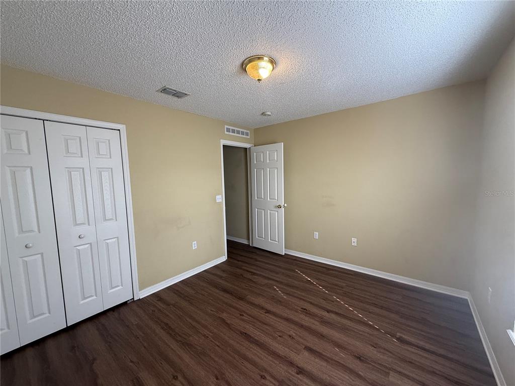 2156 Deltona Boulevard Spring Hill, FL 34606 - Photo 21 of 21 a view of an empty room with wooden floor and closet