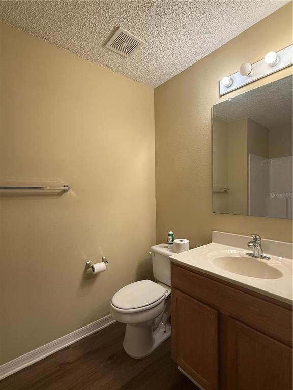 2156 Deltona Boulevard Spring Hill, FL 34606 - Photo 10 of 21 a bathroom with a toilet a sink and mirror