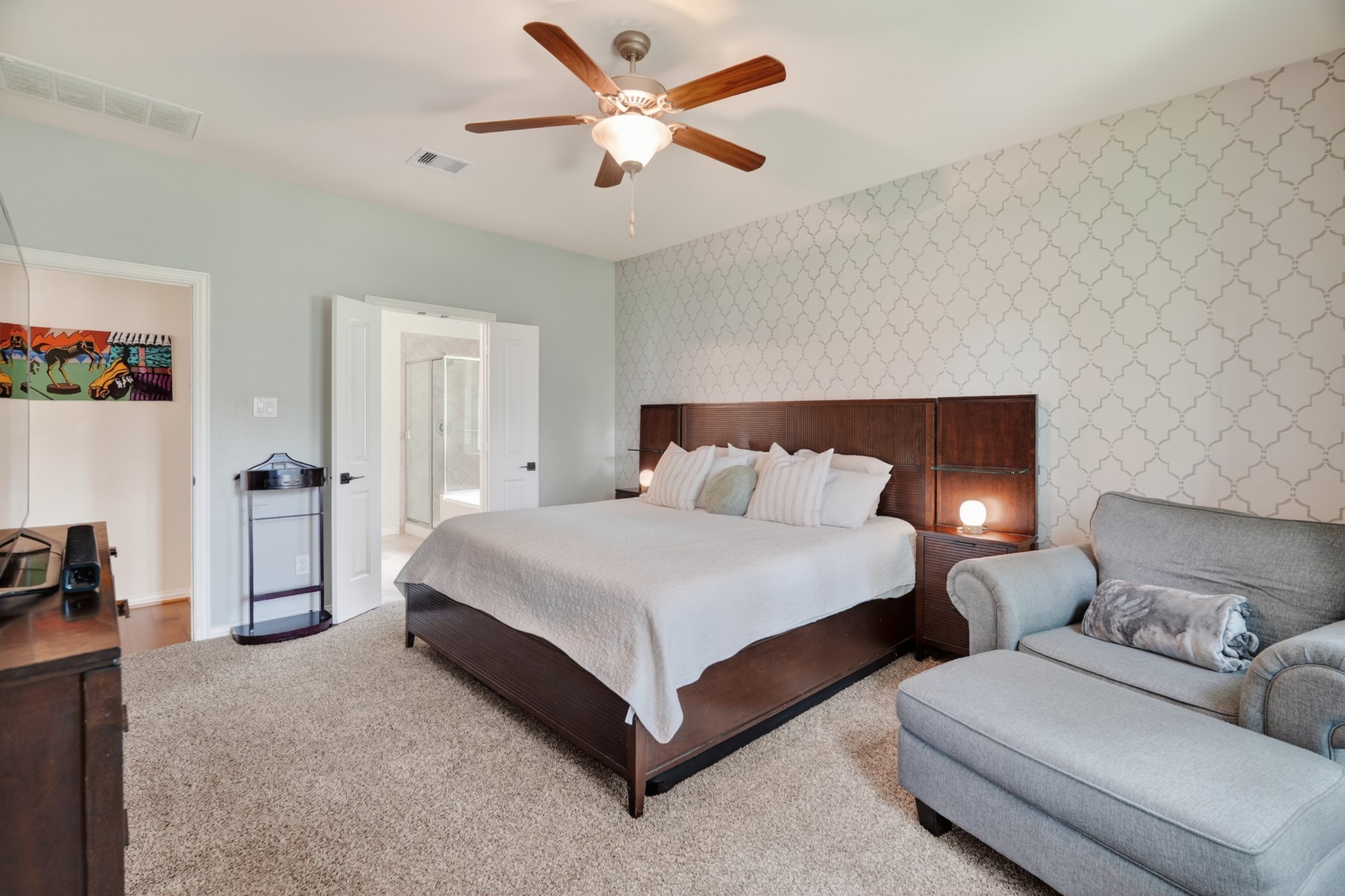 79 West Jagged Ridge Circle Spring, TX 77389 - Photo 23 of 50 This additional view of the primary bedroom highlights its comfortable proportions and direct access to the en-suite bathroom and walk-in closet. The peaceful, light-filled atmosphere makes it easy to picture unwinding here at the end of a long day.