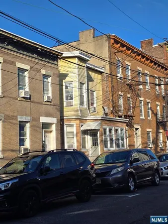 a couple of cars parked in front of a building