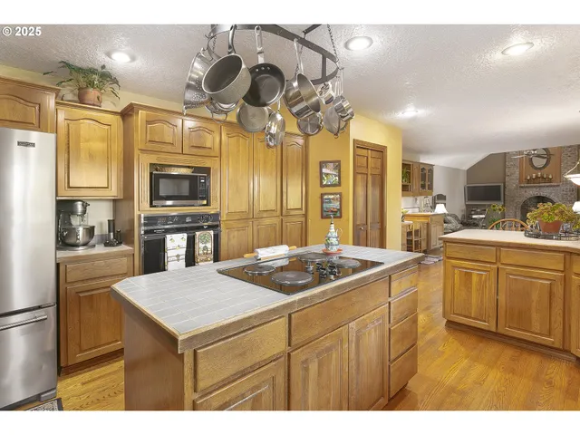 a kitchen with a sink a stove and cabinets