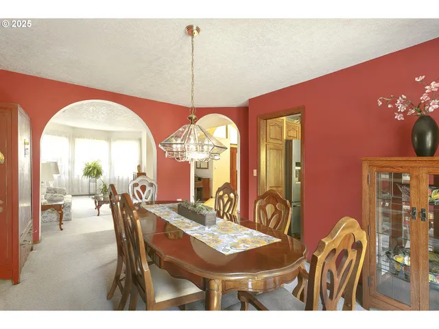 a dining room with furniture a chandelier and a rug