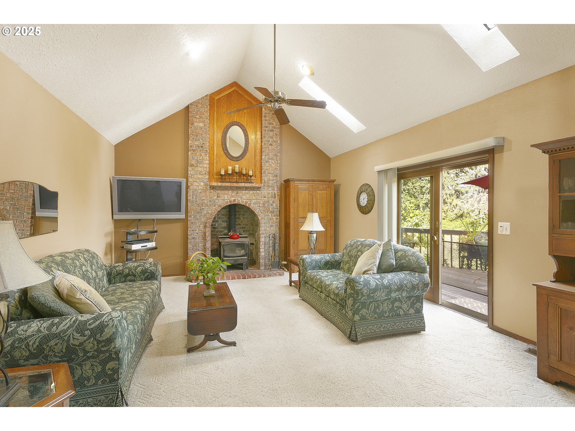 5400 Southeast Chase Road Gresham, OR 97080 - Photo 15 of 47 a living room with furniture a fireplace and a flat screen tv