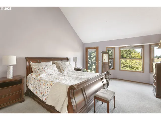 a bedroom with a bed window and a dresser