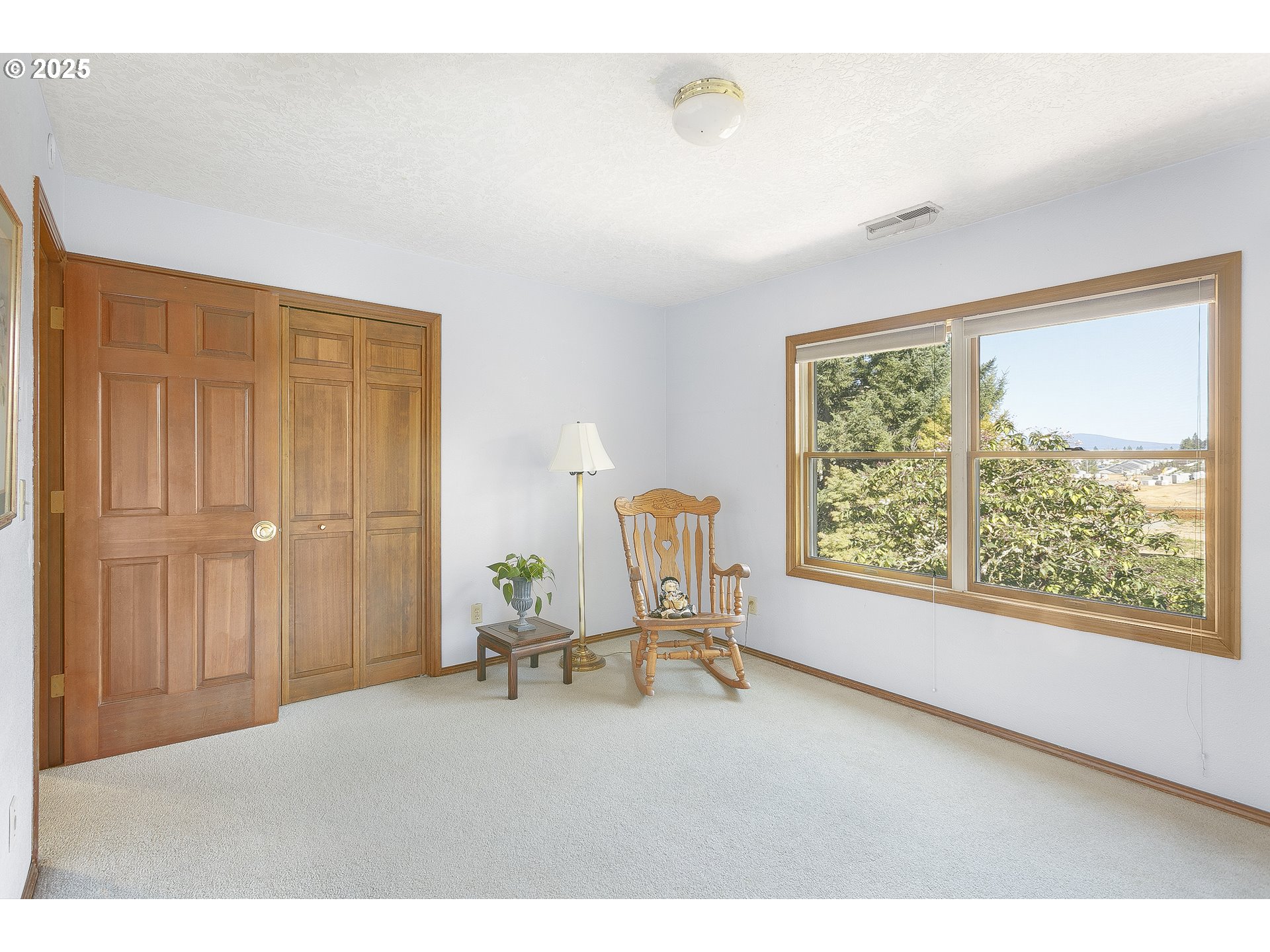 5400 Southeast Chase Road Gresham, OR 97080 - Photo 27 of 47 a chair sitting in a room next to a window