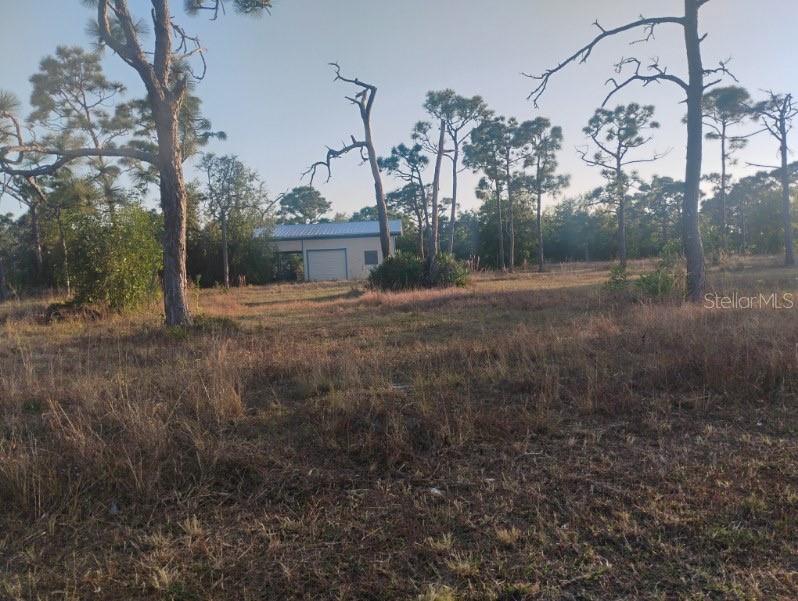 6820 Stringfellow Road St. James City, FL 33956 - Photo 2 of 4 a view of a house with a yard