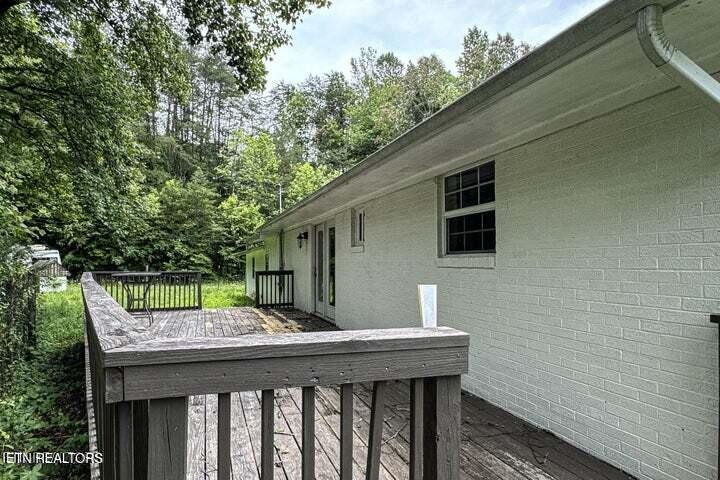 775 Middle Creek Road Cosby, TN 37722 - Photo 45 of 50 a backyard of a house with a deck and wooden floor