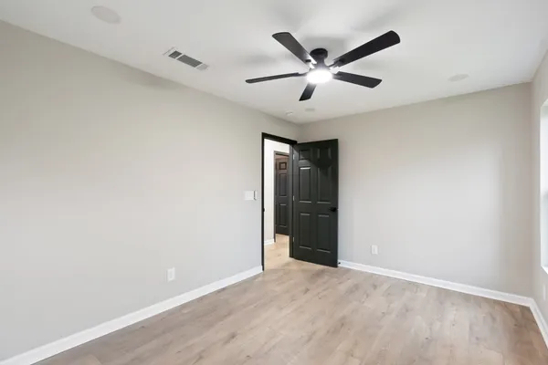 an empty room with windows and closet