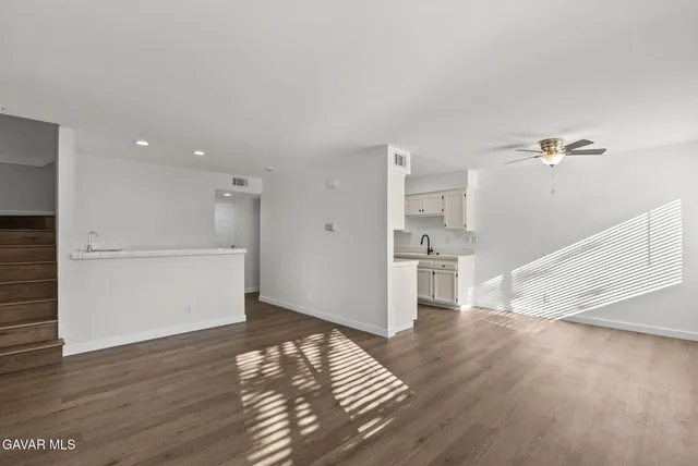 a view of empty room with wooden floor
