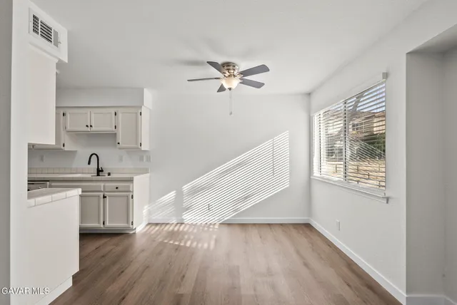a view of a kitchen with a sink cabinets and wooden floor