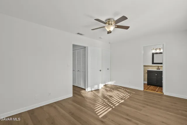 a bathroom with a toilet a sink a vanity and mirror