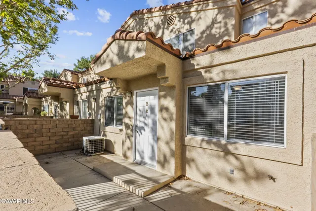 a view of a brick house with many windows