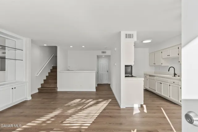 a view of a kitchen with sink and cabinets