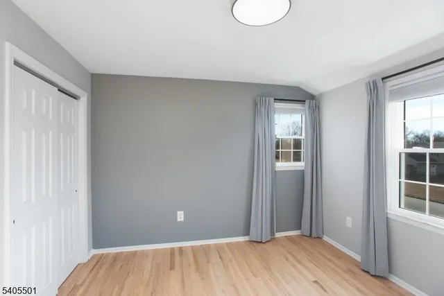 a view of room with window and wooden floor
