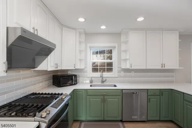 a kitchen with granite countertop a sink a stove and cabinets