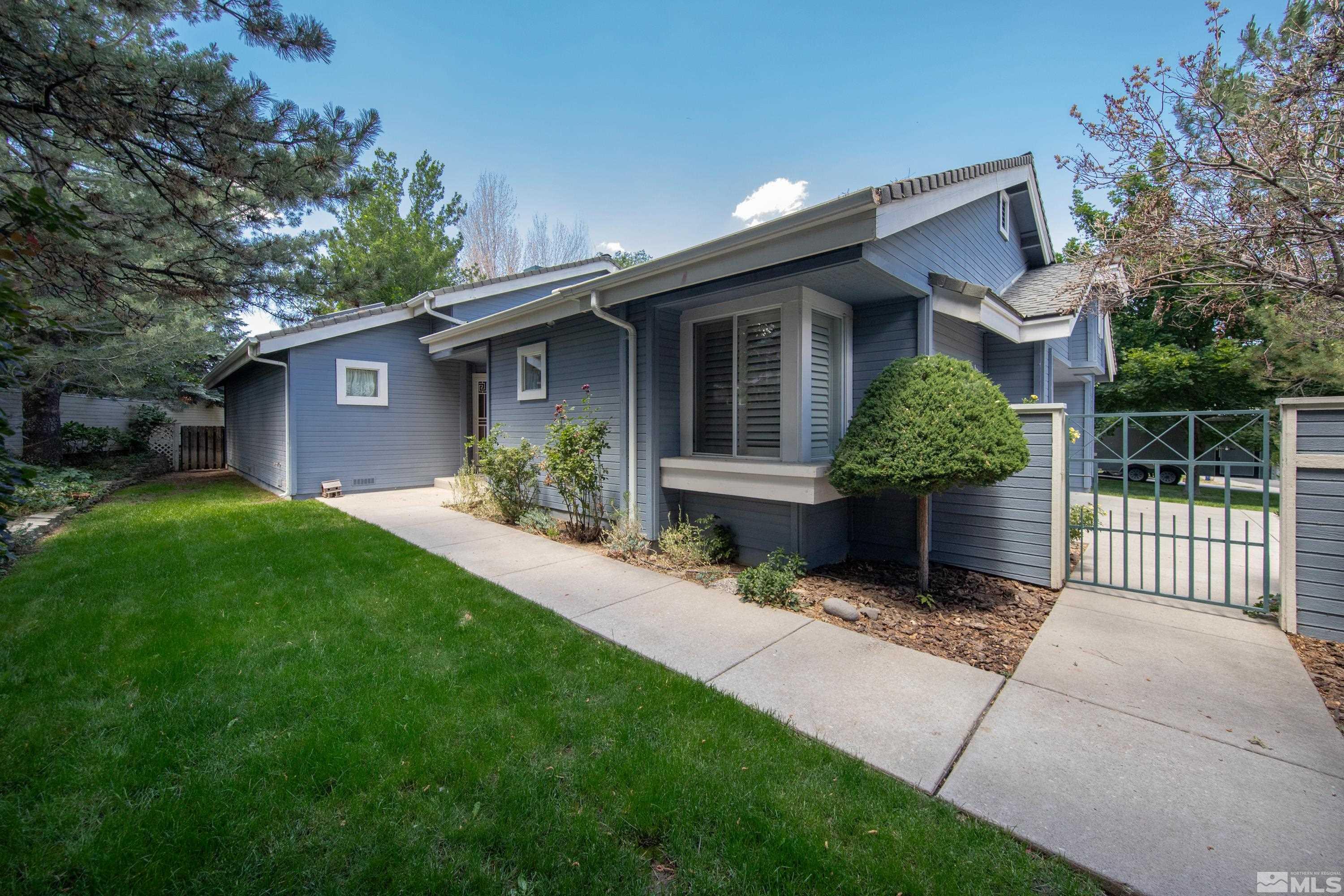 3336 Spring Creek Circle Reno, NV 89509 - Photo 1 of 36 a front view of a house with garden