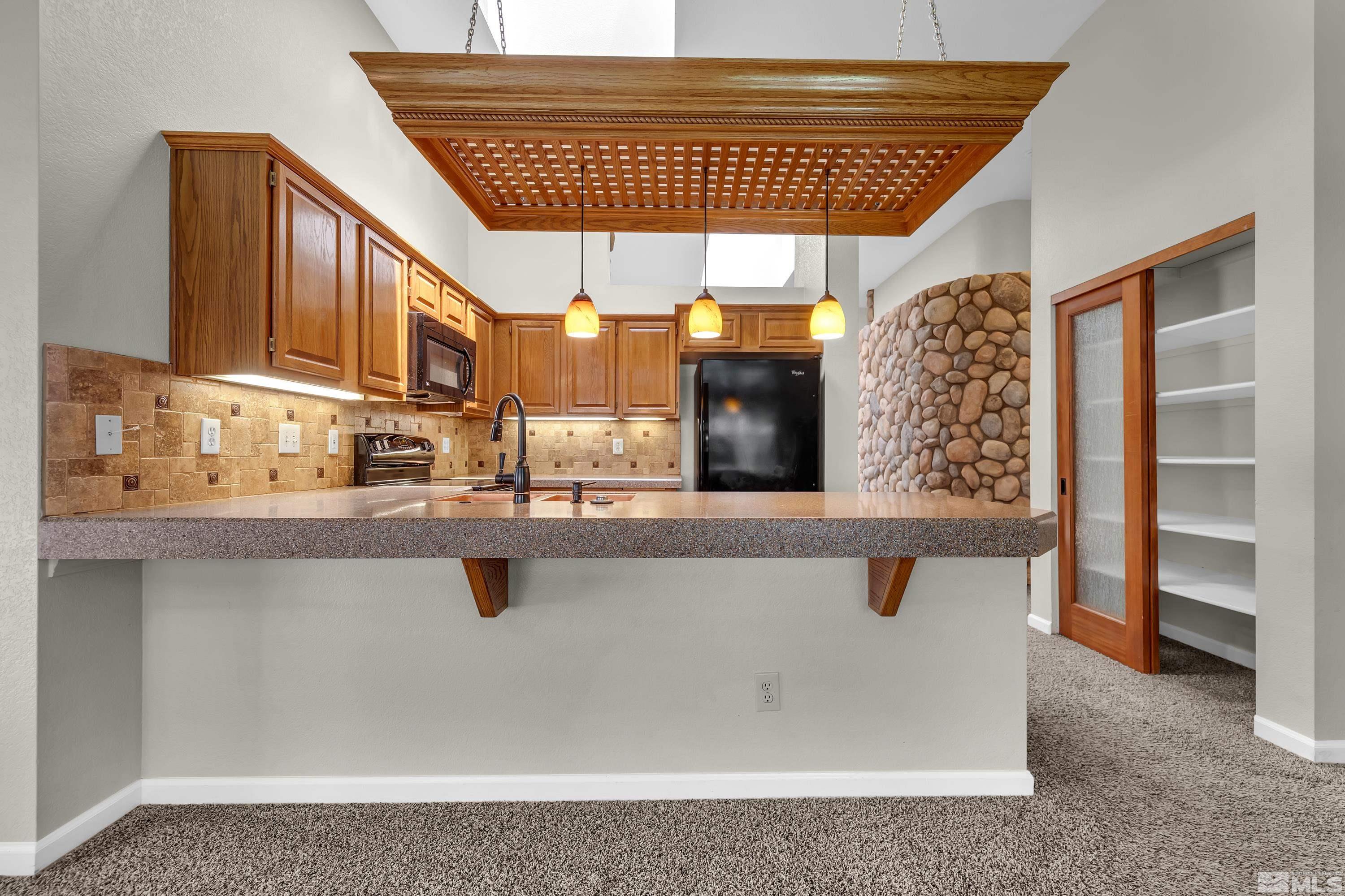 3336 Spring Creek Circle Reno, NV 89509 - Photo 13 of 36 a view of kitchen with stainless steel appliances granite countertop a sink and cabinets