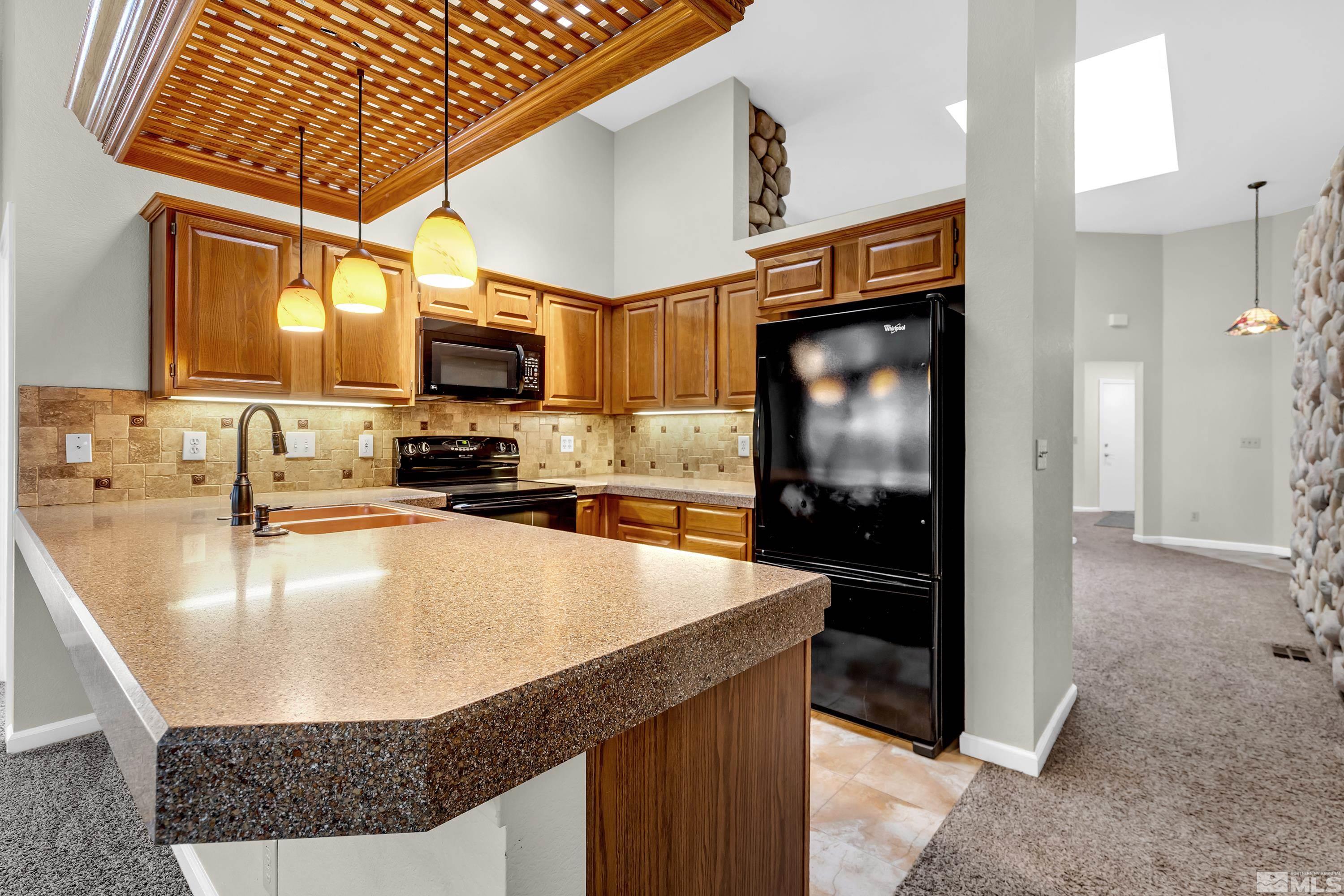 3336 Spring Creek Circle Reno, NV 89509 - Photo 14 of 36 a kitchen with a sink a counter top space cabinets and stainless steel appliances