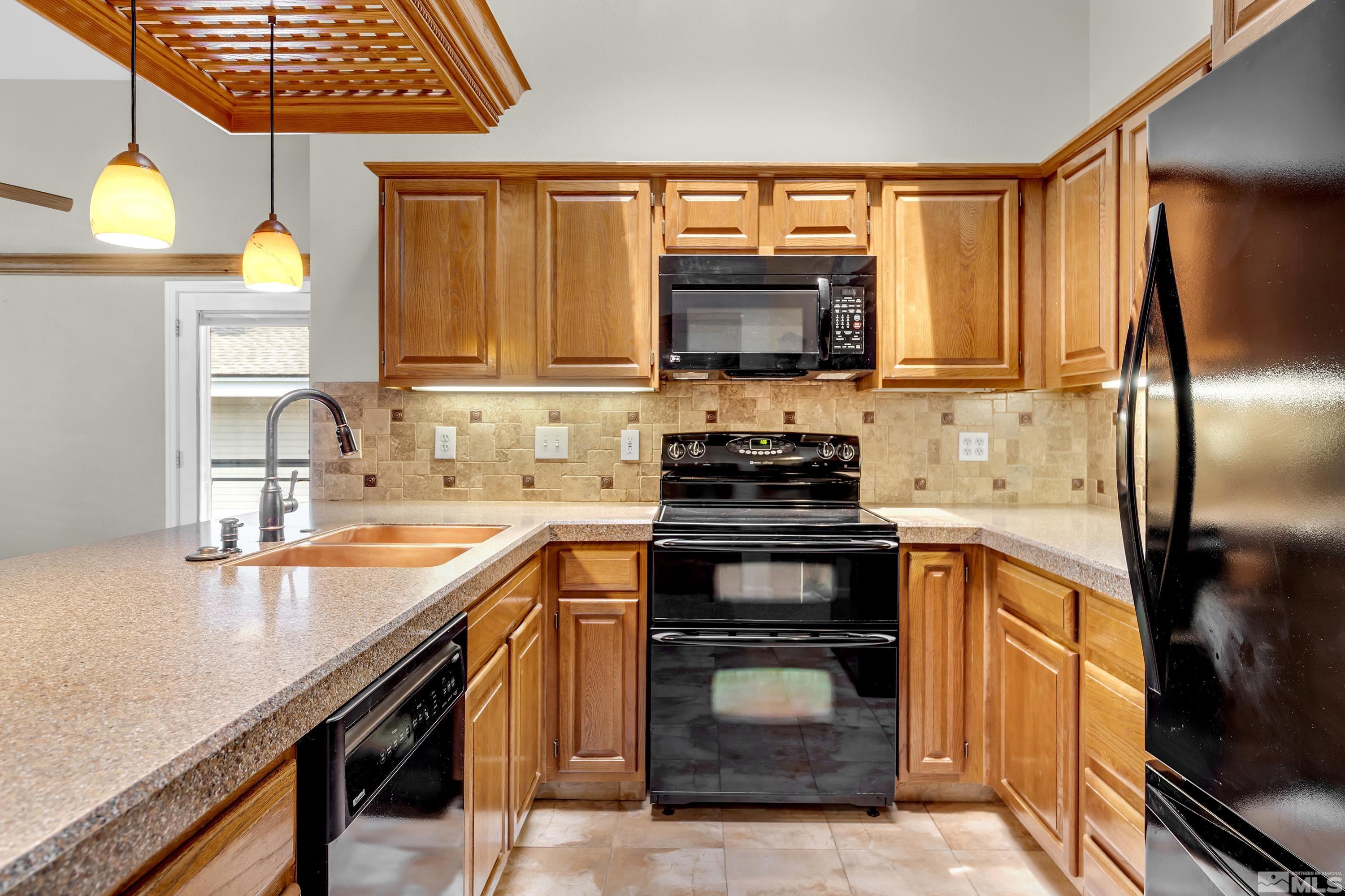 3336 Spring Creek Circle Reno, NV 89509 - Photo 15 of 36 a kitchen with a sink stove and microwave
