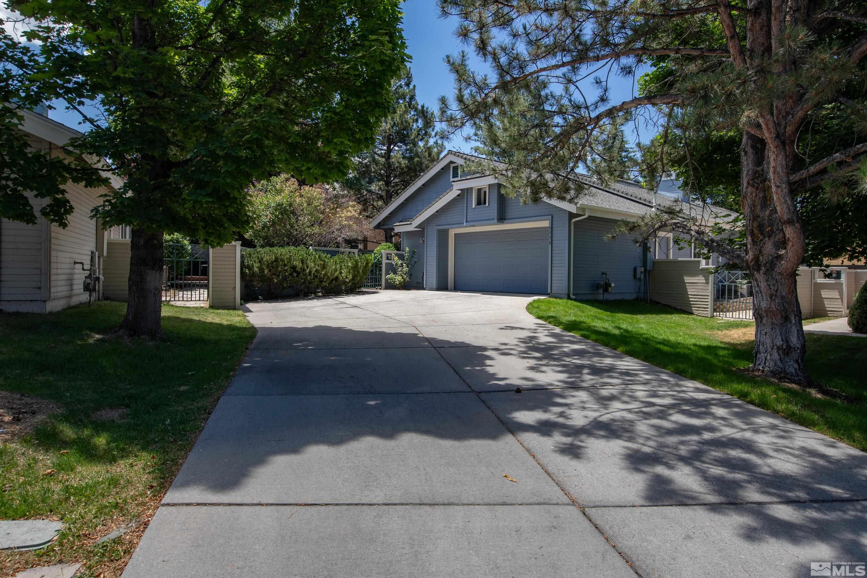 3336 Spring Creek Circle Reno, NV 89509 - Photo 3 of 36 a front view of a house with a garden and trees