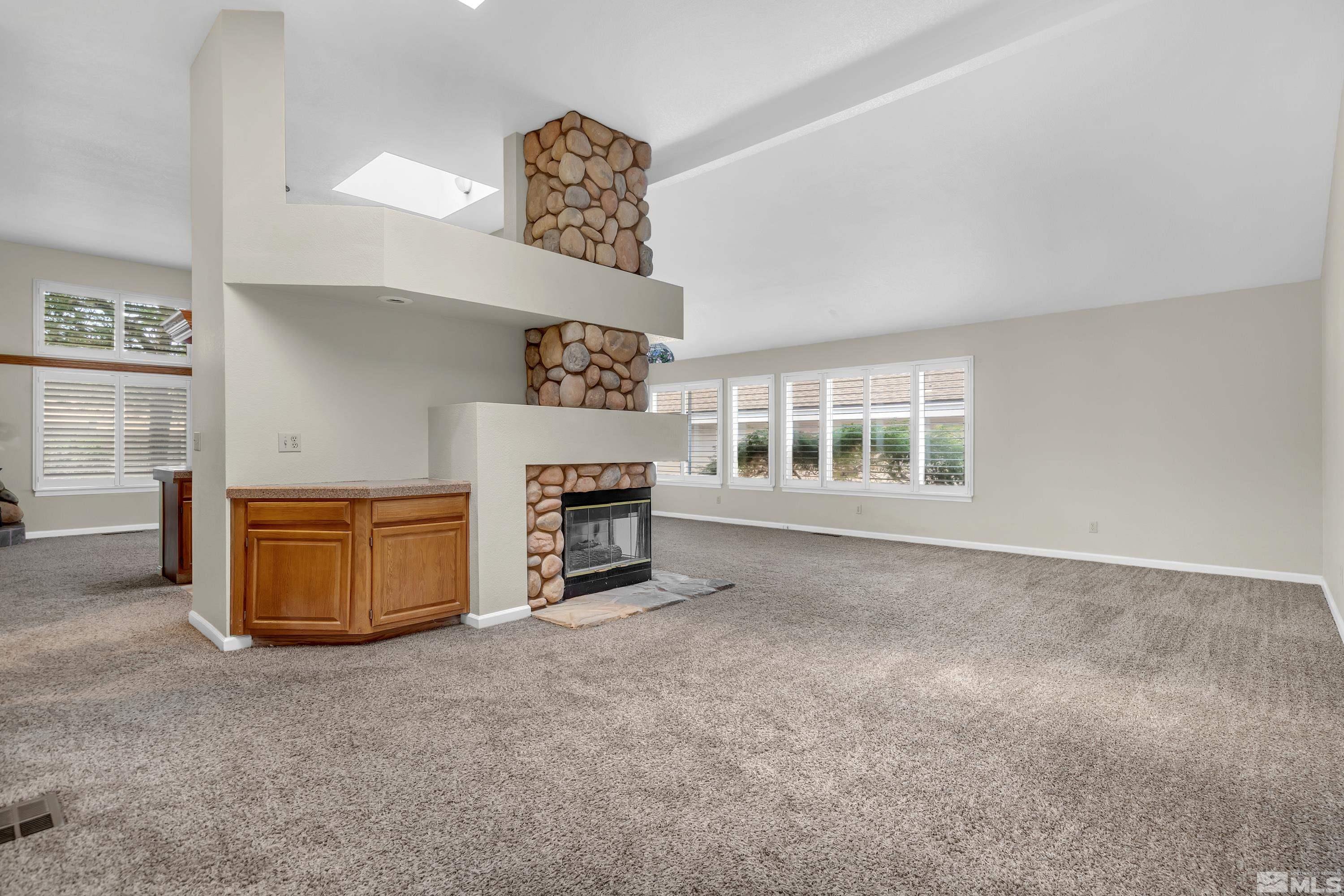 3336 Spring Creek Circle Reno, NV 89509 - Photo 5 of 36 a view of an empty room with a fireplace and a window