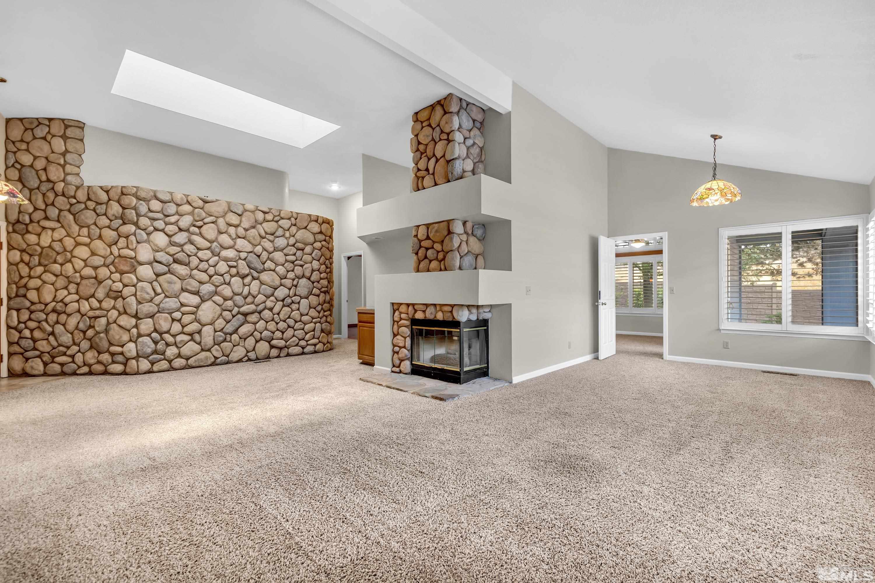 3336 Spring Creek Circle Reno, NV 89509 - Photo 6 of 36 a view of an empty room with a fireplace and a window