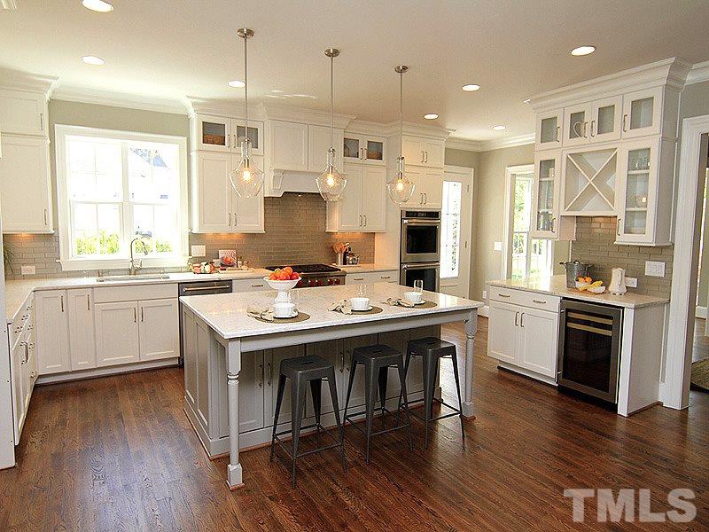 1304 Duplin Road Raleigh, NC 27607 - Photo 11 of 25 a kitchen with a sink a stove a refrigerator and cabinets