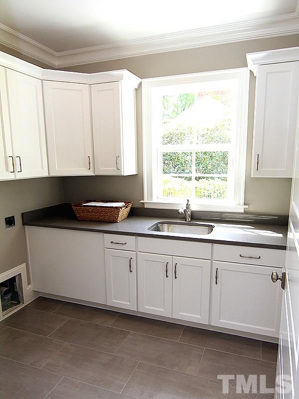 1304 Duplin Road Raleigh, NC 27607 - Photo 15 of 25 a kitchen with granite countertop white cabinets sink and window