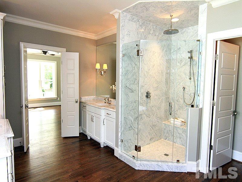 1304 Duplin Road Raleigh, NC 27607 - Photo 18 of 25 a bathroom with a shower sink and mirror
