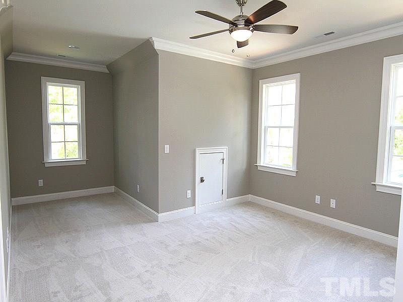 1304 Duplin Road Raleigh, NC 27607 - Photo 23 of 25 a view of an empty room with window and chandelier fan