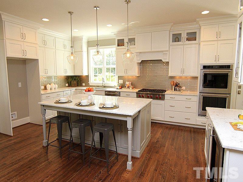 1304 Duplin Road Raleigh, NC 27607 - Photo 5 of 25 a kitchen with a sink a stove a refrigerator and a oven