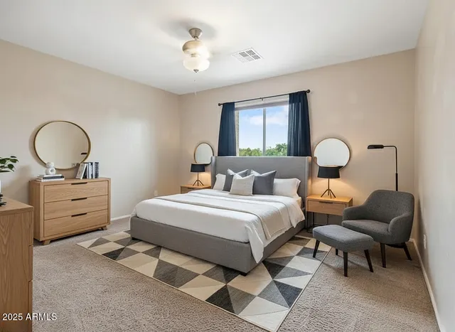 a bedroom with a bed and dresser with mirror