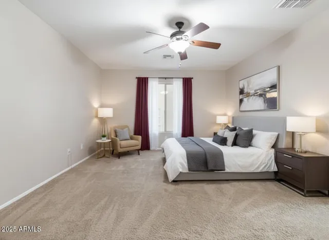 a spacious bedroom with a bed and a chandelier