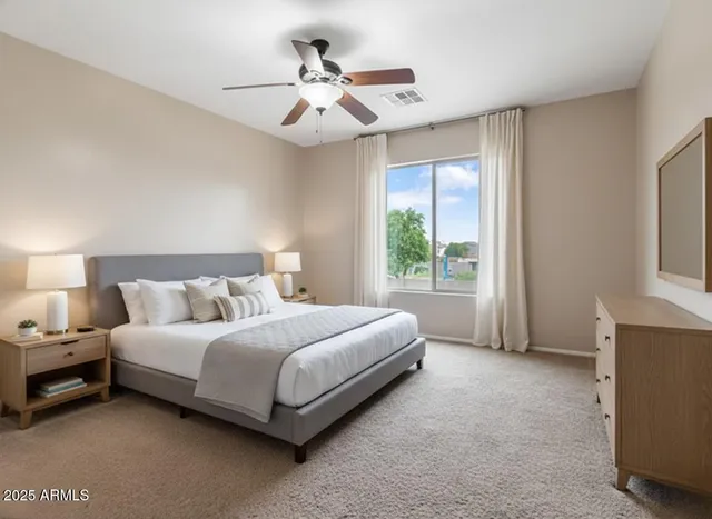 a spacious bedroom with a bed and a ceiling fan
