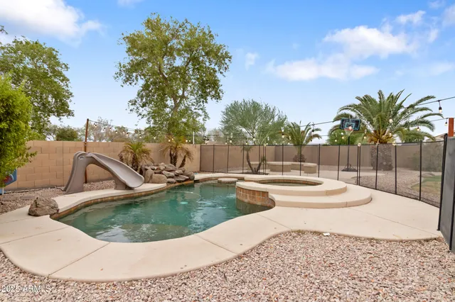 a view of a swimming pool with a lounge chair