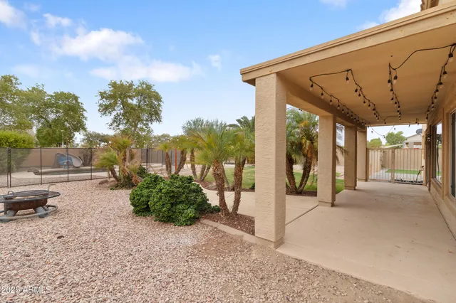 a view of a house with backyard and sitting area