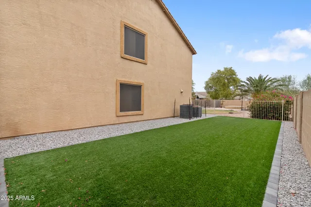 a view of yard with grass and wooden fence