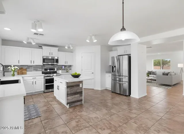 a kitchen with refrigerator and cabinets