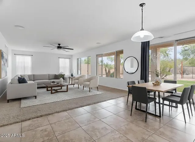 a living room with furniture a window and a clock