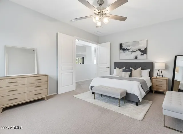 a spacious bedroom with a bed and a chandelier