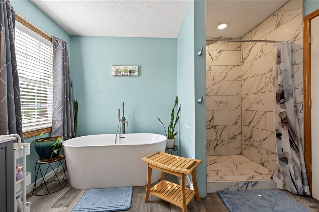 4996 Shannon Avenue Springfield, OH 45504 - Photo 35 of 61 This serene bathroom offers a soaking tub and a spacious walk-in shower for ultimate relaxation.