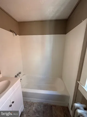 a bathroom with a bathtub and toilet