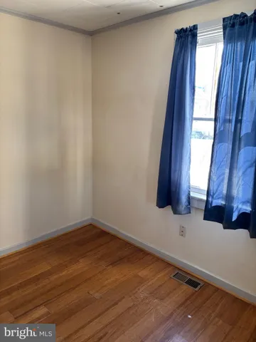 a view of an empty room and wooden floor