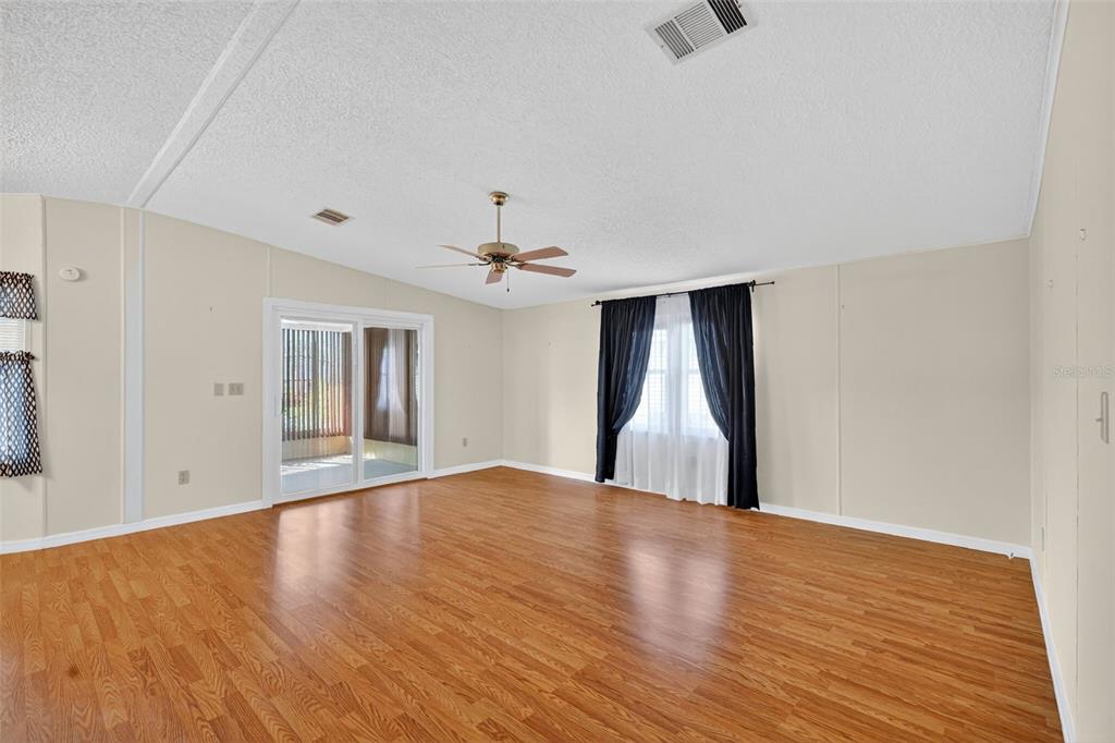 3324 Myakka River Road Tavares, FL 32778 - Photo 11 of 35 a view of an empty room with wooden floor and a window