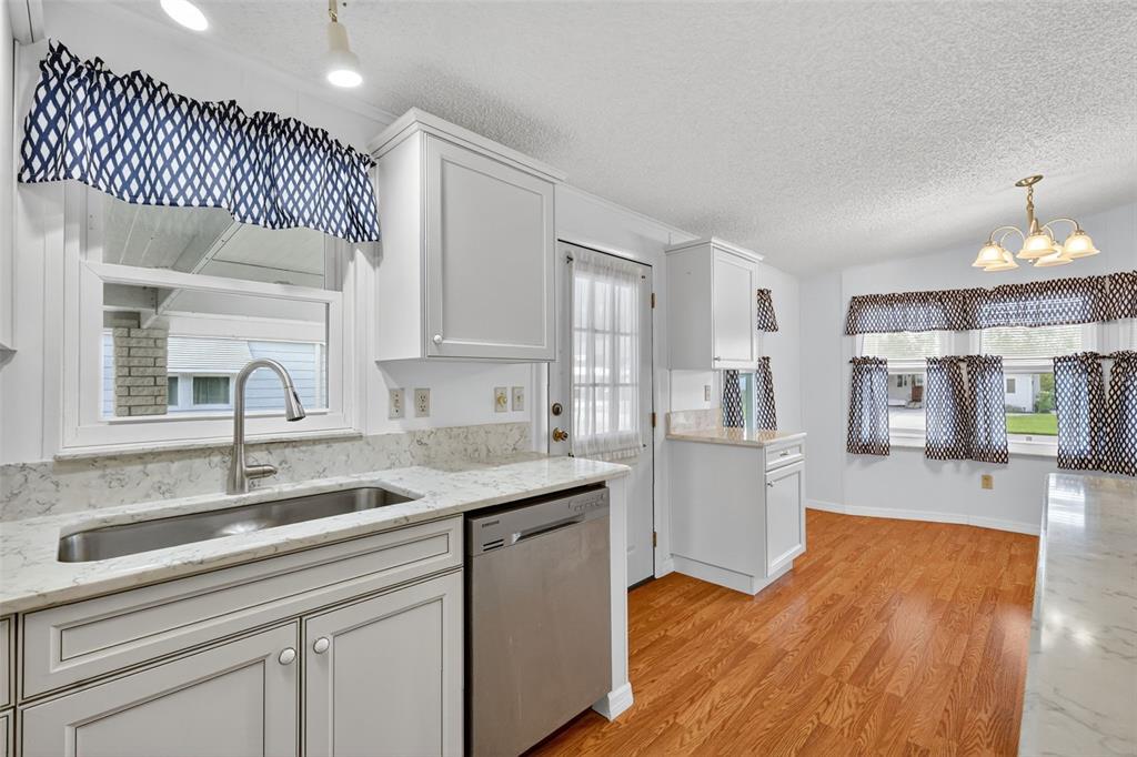 3324 Myakka River Road Tavares, FL 32778 - Photo 15 of 35 a kitchen with a sink cabinets and wooden floor